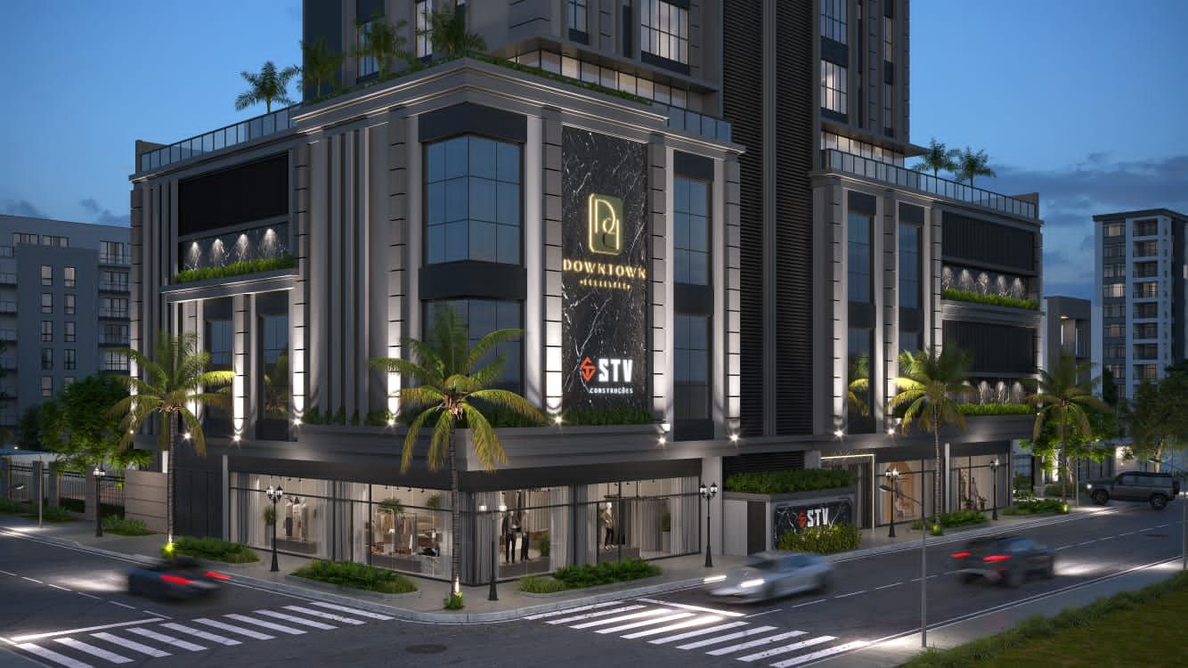 Fachada do empreendimento Downtown Boulevard da STV Construções ao anoitecer com carros com os farois acesos mostra
