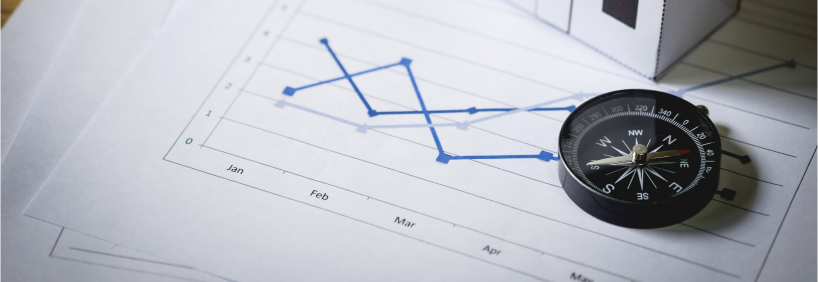 Gráficos sob a mesa simbolizando inteligencia imobiliaria